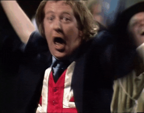 a man wearing a red white and blue vest that says l on it