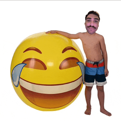 a shirtless man stands next to a large yellow smiley face with tears coming out of its eyes