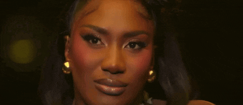 a close up of a woman 's face with a necklace and earrings .