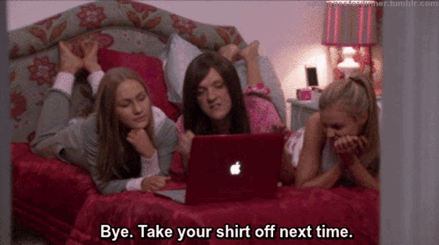 three girls are laying on a bed looking at a laptop and one of them is saying bye take your shirt off next time