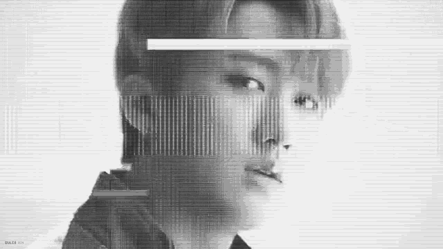 it is a black and white photo of a man 's face with a glitch effect .