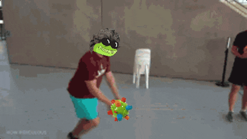 a pixelated image of a person holding a ball with a face on it