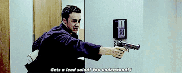 a man holding a gun with the words gets a lead salad you understand