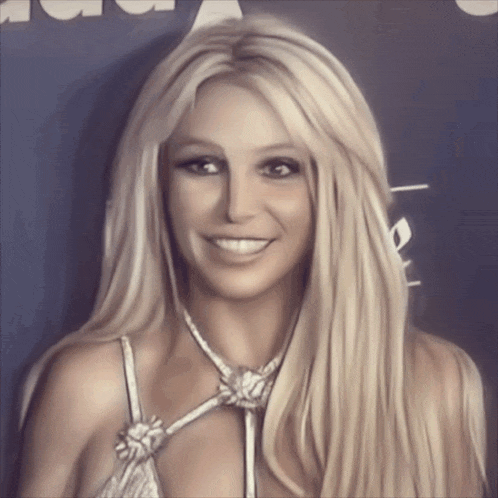 a woman with long blonde hair is smiling and wearing a white top