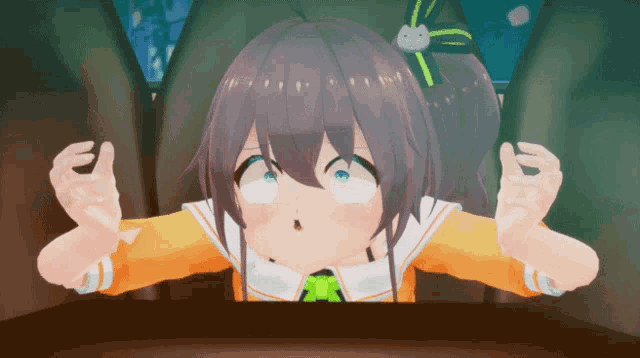 a cartoon girl with a green bow on her head is sitting at a table
