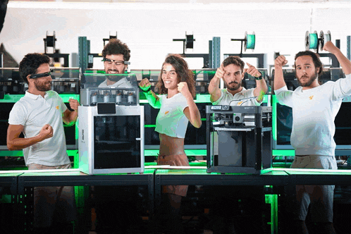 a group of people are standing in front of a 3d printer that says ' a3d ' on it