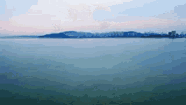 a painting of a body of water with mountains in the background