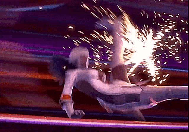 a person is flying through the air with sparks coming out of it
