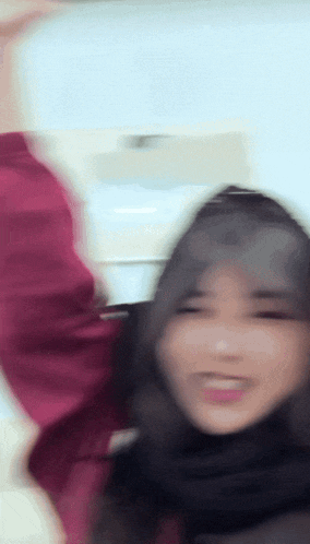 a blurry picture of a woman with her arms up in the air