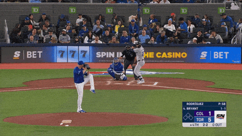 a baseball game is being played in front of a sbet banner