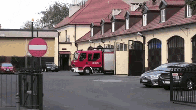 a red fire truck is parked in a parking lot
