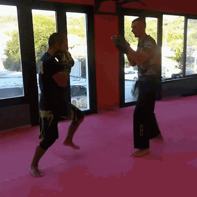 a man in a black shirt with the number 7 on it is boxing