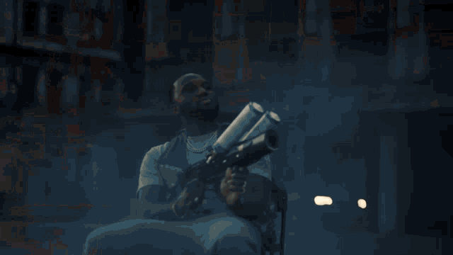 a man is holding a torch with flames coming out of it while sitting down