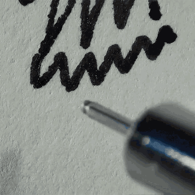 a close up of a pen with the letter m on it