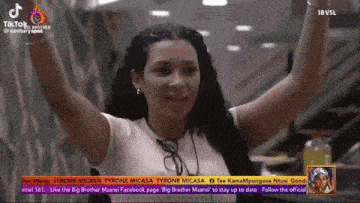 a woman in a white shirt with her arms in the air is on a tv screen that says tiktok
