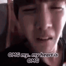 a close up of a person 's face with the words `` omg my , my heart is omg '' .