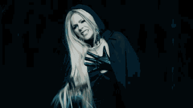 a woman in a black cape and black gloves