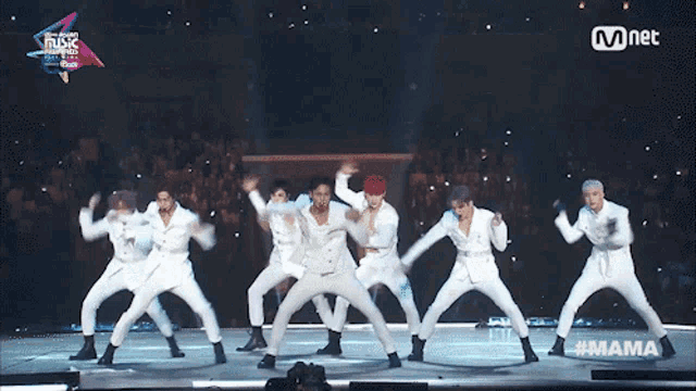a group of men are dancing on a stage with the hashtag #mama