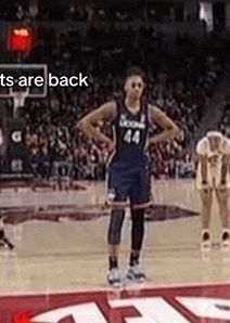 a basketball player with the number 44 on his jersey is standing on the court .