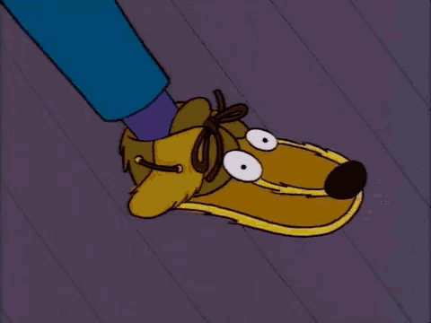 mr. simpson from the simpsons is holding a plate up in the air .