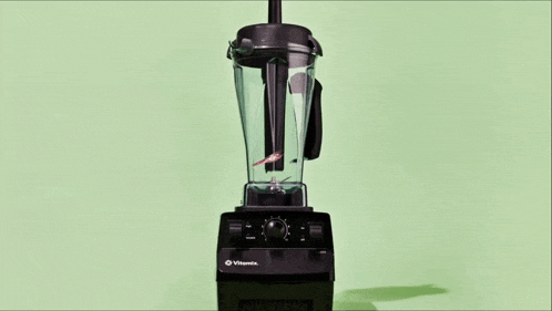 a vitamix blender is being used to make a smoothie .