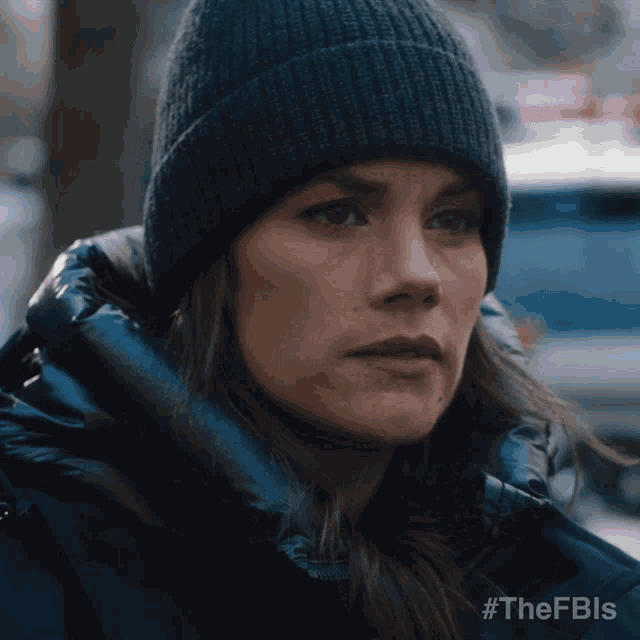 a close up of a woman wearing a beanie with the hashtag #thefbls on the bottom