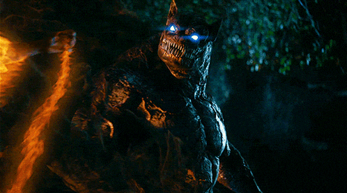 a monster with blue eyes and sharp teeth