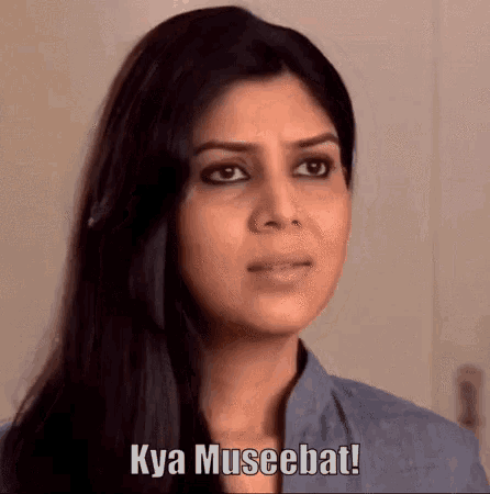 a woman says kya museebat in front of a wall