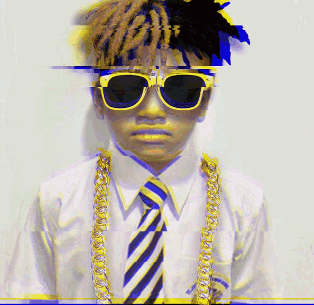 a man wearing sunglasses and a tie has a necklace around his neck