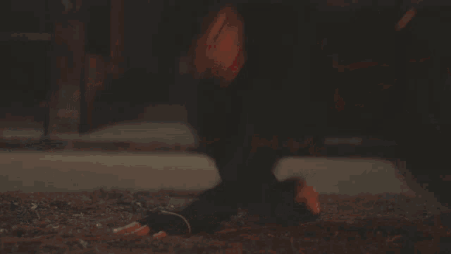 a blurred image of a person laying on the ground with the letters kc visible