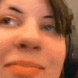 a close up of a woman 's face with a red lip and headphones on .