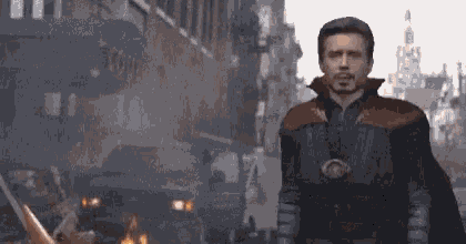 a man in a doctor strange costume stands in front of a burning building