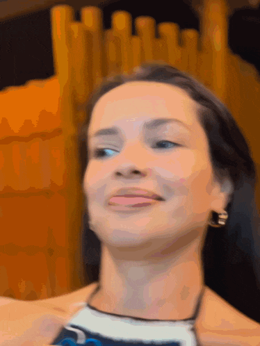 a close up of a woman 's face making a funny face