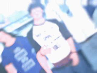 a blurry picture of a man wearing a shirt that says " bro " on it
