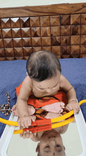 a baby is playing with a toy bow and arrow