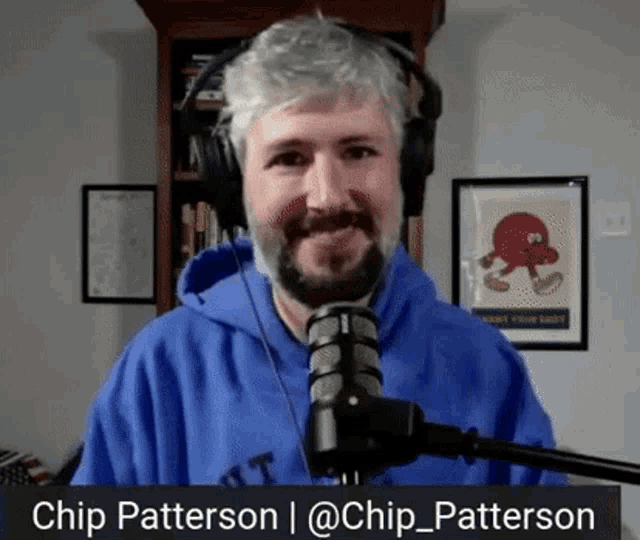 a man wearing headphones and a blue hoodie stands in front of a microphone with the name chip patterson at the bottom