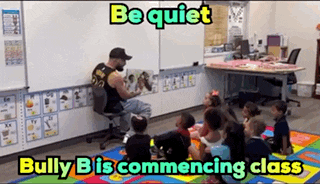 a man is reading a book to a group of children in a classroom while bully b is commencing class