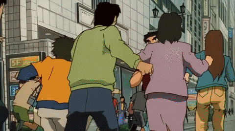 a group of people are running down a street in front of a building with the number 5f on it