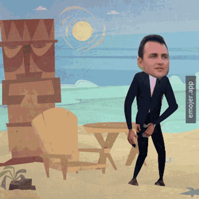 a man in a suit and tie is standing on a beach with a totem pole in the background
