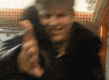 a blurry picture of a man talking on a telephone