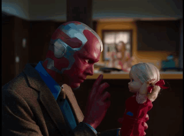 a man with red eyes is holding a doll in his hands