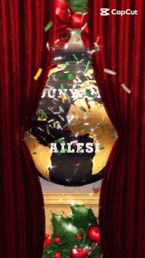 a red curtain is open to reveal a christmas decoration with the word ailesi on it