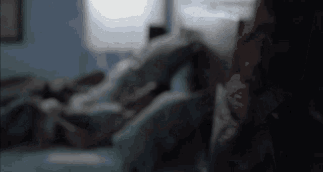 a blurred image of a person laying on a bed