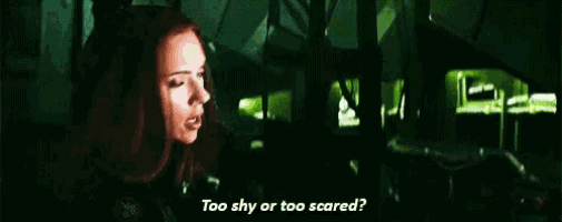 a woman with red hair is asking if she is too shy or too scared in a dark room .