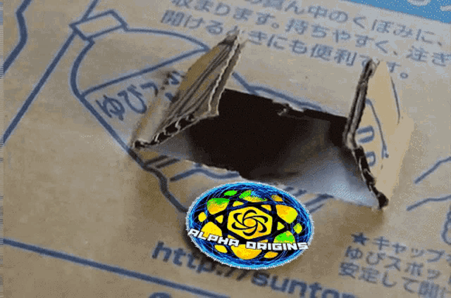 a cardboard box has a hole in it and says alpha origins