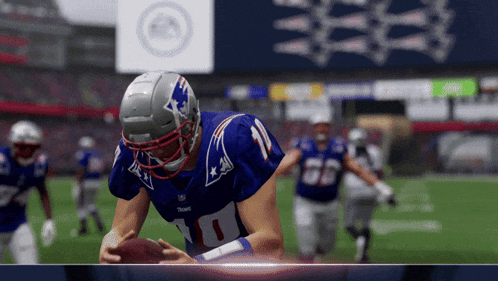 a football player wearing a number 10 jersey is holding a football