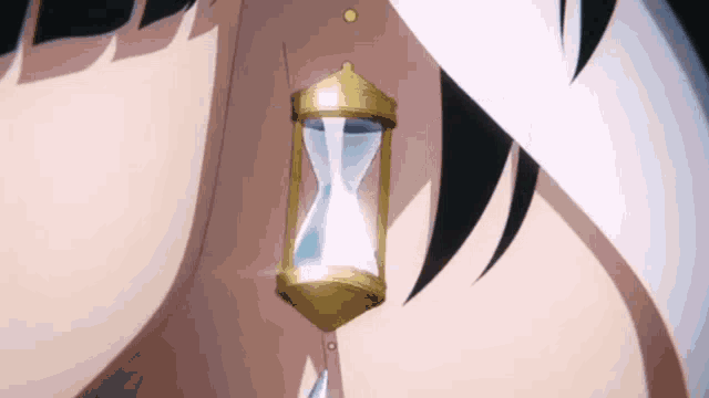 a person is wearing a hourglass earring .
