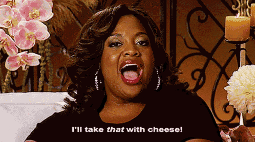 a woman says i 'll take that with cheese while sitting on a couch