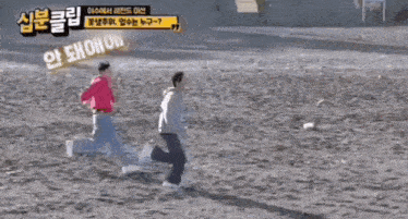 a man is jumping into a body of water on the beach