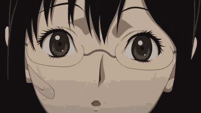 a close up of a girl wearing glasses looking at the camera
